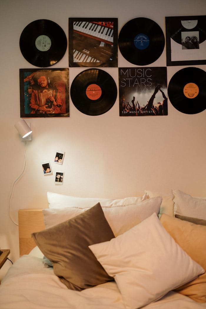 services-01 A stylish bedroom interior with vinyl records and cozy pillows.